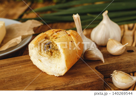 Sliced fresh baguette with garlic oil and herbs Sliced fresh baguette with garlic oil and herbs 140269544