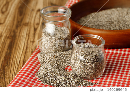 Glass bowl with chia seeds on wooden table Glass bowl with chia seeds on wooden table 140269646