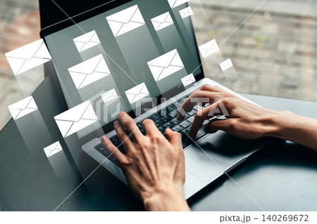 Person typing on laptop with multiple email notifications appearing on screen Person typing on laptop with multiple email notifications appearing on screen 140269672