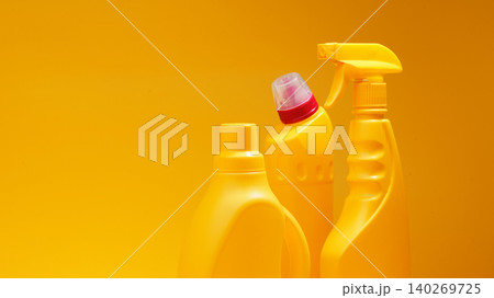 Cleaning products arranged on a bright yellow background in a simple setting Cleaning products arranged on a bright yellow background in a simple setting 140269725