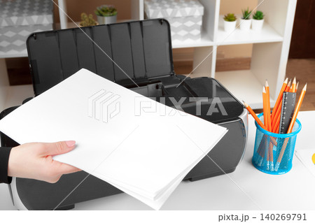 Woman using the printer to scanning and printing document Woman using the printer to scanning and printing document 140269791