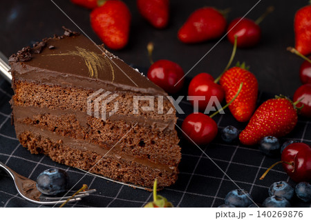Piece of chocolate cake served with fresh berries Piece of chocolate cake served with fresh berries 140269876