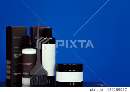 Hair coloring cosmetic products in black packages with copy space 140269987