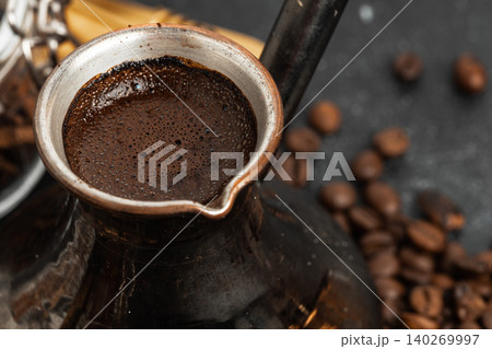 Coffee beans and turk on dark surface Coffee beans and turk on dark surface 140269997