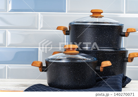 New black cookware with wooden handles close up 140270071
