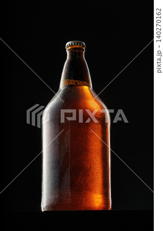 Beer bottle on dark background, copy space Beer bottle on dark background, copy space 140270162