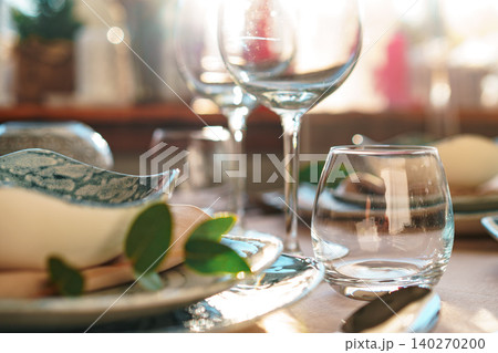 Beautiful elegant table setting with green stylish dishware and silver cutlery 140270200