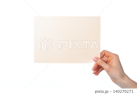 Woman's hand holding blank white sheet of paper isolated on white Woman's hand holding blank white sheet of paper isolated on white 140270271