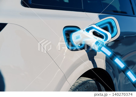 Electric car gets charged at a public charging station in the afternoon light Electric car gets charged at a public charging station in the afternoon light 140270374
