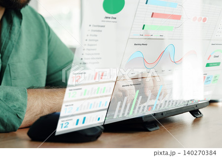 Business professional reviewing digital charts on a screen in modern office setting Business professional reviewing digital charts on a screen in modern office setting 140270384