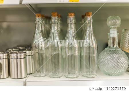 Glass bottles and decorative containers displayed on home decor store shelf Glass bottles and decorative containers displayed on home decor store shelf 140271579