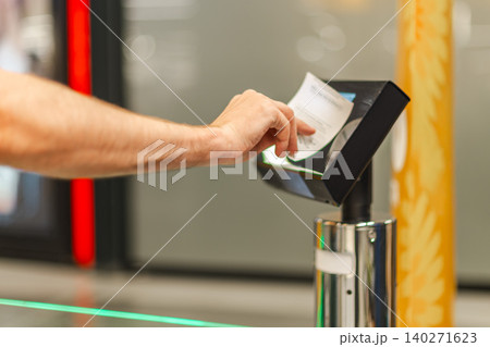 Man scanning paper receipt at self checkout terminal, using automated retail system for purchase verification and secure supermarket transaction Man scanning paper receipt at self checkout terminal, using automated retail system for purchase verification and secure supermarket transaction 140271623