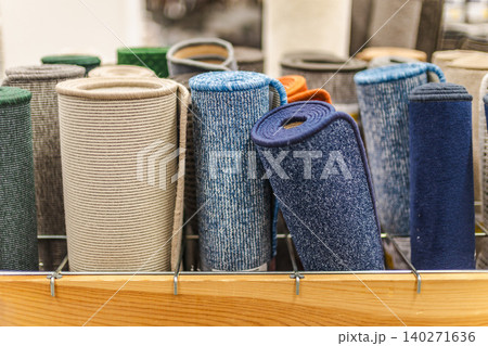 Rolled carpet samples and colorful floor mats displayed in home improvement store Rolled carpet samples and colorful floor mats displayed in home improvement store 140271636