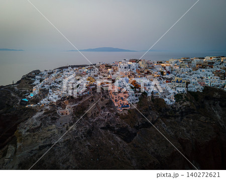 A breathtaking aerial view of the whitewashed village of Oia, Santorini, showcasing luxury resorts with infinity pools overlooking the Aegean Sea. A stunning blend of Cycladic architecture A breathtaking aerial view of the whitewashed village of Oia, Santorini, showcasing luxury resorts with infinity pools overlooking the Aegean Sea. A stunning blend of Cycladic architecture 140272621