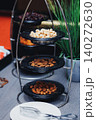 Metal tiered stand holds assorted nuts 140272630