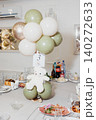 Soft balloons float above a festive table setting 140272633