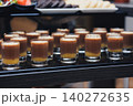 Rows of chocolate-and-fruit shots gleam in clear glass cups 140272635
