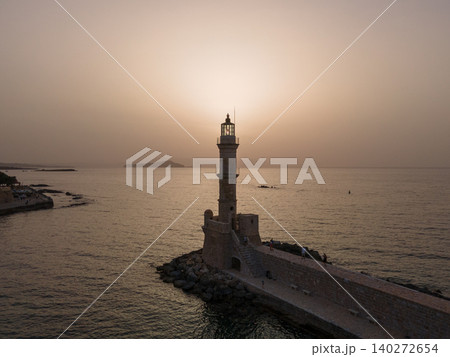 A scenic view of the Old Venetian Harbor in Rethymno, Crete, Greece. This historic port features charming waterfront tavernas, colorful boats, and a majestic lighthouse, reflecting its rich heritage A scenic view of the Old Venetian Harbor in Rethymno, Crete, Greece. This historic port features charming waterfront tavernas, colorful boats, and a majestic lighthouse, reflecting its rich heritage 140272654