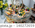 Elegant tiered stand holds savory appetizers 140272659