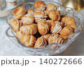 Golden choux pastries sit in a clear glass bowl 140272666