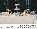 Elegant table set with sweet treats and decorative stands 140272673