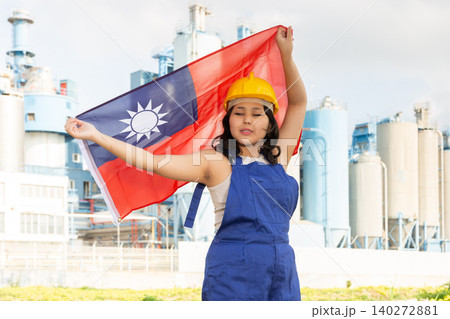 Happy asian girl in work clothes and hardhat with flag of taiwan standing in front of industrial scenery Happy asian girl in work clothes and hardhat with flag of taiwan standing in front of industrial scenery 140272881