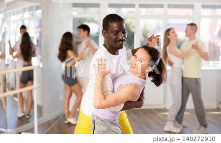 African American performing kizomba with woman in dance studio African American performing kizomba with woman in dance studio 140272910