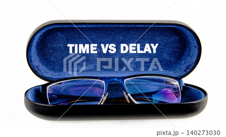 Stylish glasses rest inside a sleek case, showcasing the phrase time vs delay in bold letters, inviting reflection on the impact of time on experiences Stylish glasses rest inside a sleek case, showcasing the phrase time vs delay in bold letters, inviting reflection on the impact of time on experiences 140273030
