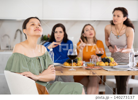 Group of women quarreling with asian woman Group of women quarreling with asian woman 140273137
