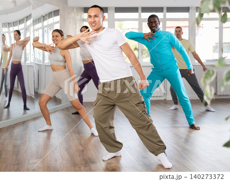 Young Asian dancer rehearsing krump moves at group workout 140273372