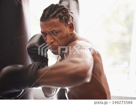 Battle, portrait and black man with boxing gloves in gym for challenge, fight and competition training. Power, muscle and serious face of champion boxer at workout with confidence in sports club. Battle, portrait and black man with boxing gloves in gym for challenge, fight and competition training. Power, muscle and serious face of champion boxer at workout with confidence in sports club. 140273566