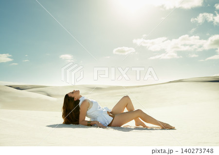 Desert, woman and fashion with sunshine, beauty and relaxing with confidence and getaway trip. Person, outdoor and sand with girl and clouds with blue sky and summer with weekend break and travelling Desert, woman and fashion with sunshine, beauty and relaxing with confidence and getaway trip. Person, outdoor and sand with girl and clouds with blue sky and summer with weekend break and travelling 140273748