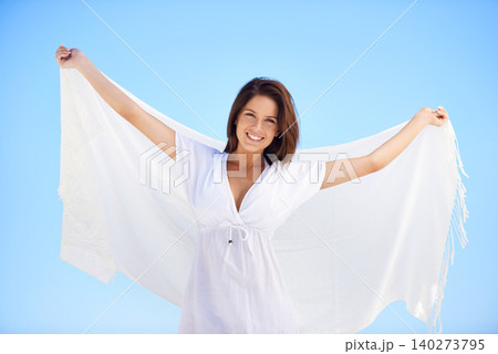Portrait, happy woman and fabric in wind outdoor for summer, vacation and travel on holiday. Face, smile and person fly with silk sarong in the air for freedom, beauty and breeze on blue sky in Spain Portrait, happy woman and fabric in wind outdoor for summer, vacation and travel on holiday. Face, smile and person fly with silk sarong in the air for freedom, beauty and breeze on blue sky in Spain 140273795