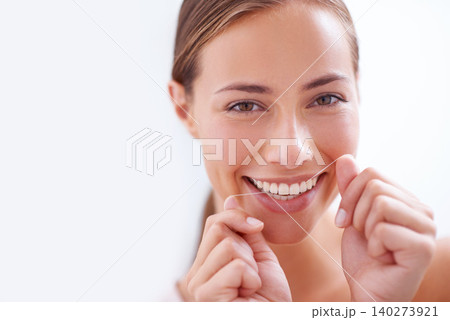 Woman, teeth and floss in portrait for dental hygiene with closeup, morning and cleaning mouth for dentistry. Female person, tooth care and routine for healthy, face and fresh smile for beauty Woman, teeth and floss in portrait for dental hygiene with closeup, morning and cleaning mouth for dentistry. Female person, tooth care and routine for healthy, face and fresh smile for beauty 140273921
