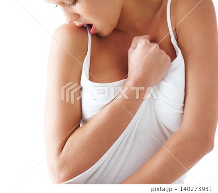Emotion, feeling and grabbing clothes with woman in studio isolated on white background for release. Hands, sexy and sensual with young feminine person closeup for desire, passion or satisfaction 140273931