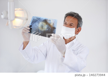 Senior dentist, man and xray of teeth for dental surgery, healthcare and oral health with face mask in clinic. Medical professional with analysis of scan, radiology and orthodontics with mouth care Senior dentist, man and xray of teeth for dental surgery, healthcare and oral health with face mask in clinic. Medical professional with analysis of scan, radiology and orthodontics with mouth care 140273944