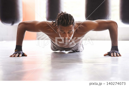 Portrait, exercise and push up with black man on floor of gym for training strong muscles or power. Fitness, health and body with confident young athlete in workout to improve physical wellness Portrait, exercise and push up with black man on floor of gym for training strong muscles or power. Fitness, health and body with confident young athlete in workout to improve physical wellness 140274073