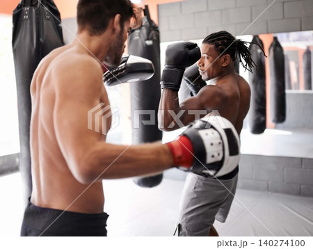 Men, training for boxing and fitness, sport and coaching with athlete and personal trainer for workout in gym. Exercise, skill and kickboxing with boxer team practice, MMA and challenge with action Men, training for boxing and fitness, sport and coaching with athlete and personal trainer for workout in gym. Exercise, skill and kickboxing with boxer team practice, MMA and challenge with action 140274100