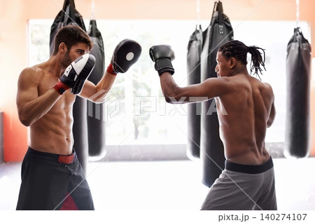 Men, training for boxing in gym and exercise, sport and coaching with athlete and personal trainer for workout. Fitness, skill and kickboxing with boxer team practice, MMA and challenge with action Men, training for boxing in gym and exercise, sport and coaching with athlete and personal trainer for workout. Fitness, skill and kickboxing with boxer team practice, MMA and challenge with action 140274107
