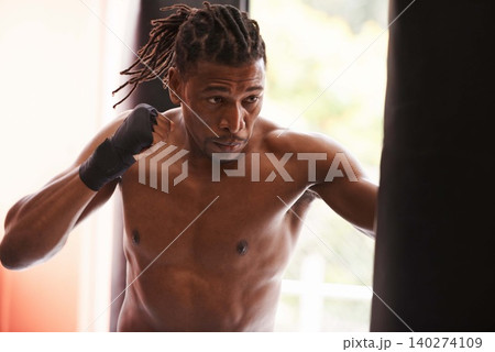 Fitness, punching bag and black man in gym for fight, exercise or boxing competition training. Power, muscle and serious champion boxer at workout with confidence, challenge and energy in sports club 140274109