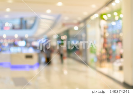 Defocused shopping mall interior bright lights retail storefronts modern architecture creating soft commercial background ample copy space 140274241