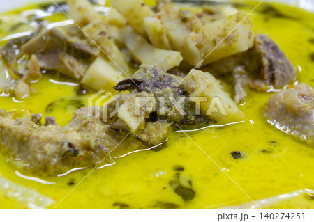 Close up of Thai green curry tender meat bamboo shoots rich coconut broth Traditional cuisine aromatic herbs vibrant color savory flavor Close up of Thai green curry tender meat bamboo shoots rich coconut broth Traditional cuisine aromatic herbs vibrant color savory flavor 140274251