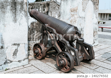 Ancient Portuguese bronze cannon on carriage at unesco monte fortress historical monument and famous landmark in Macau ruins of st paul area China Ancient Portuguese bronze cannon on carriage at unesco monte fortress historical monument and famous landmark in Macau ruins of st paul area China 140274502