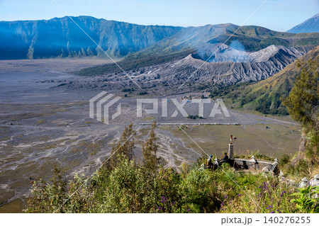 Tourist looking to the crater of Mt.Bromo an active somma volcano in East Java, Indonesia from viewpoint. 140276255