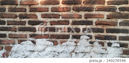 Weathered brick wall with rough cement plaster texture background 140276546