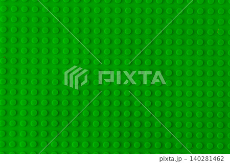 Green plastic building blocks baseplate texture, top view toy brick board pattern background. Green plastic building blocks baseplate texture, top view toy brick board pattern background. 140281462