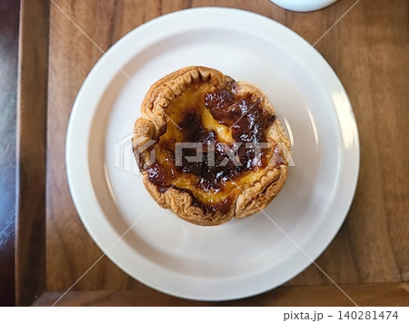 Golden egg tart with a flaky, buttery crust and a rich, creamy custard center. A deliciously satisfying treat for dessert or a light snack, blending texture and flavor perfectly. 140281474