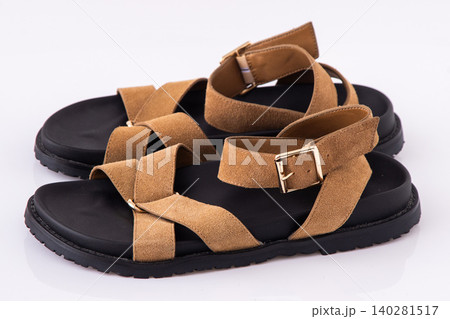 Stylish Brown Suede Summer Sandals on white background, Comfortable Casual Flat Platform Strappy Shoes top view Stylish Brown Suede Summer Sandals on white background, Comfortable Casual Flat Platform Strappy Shoes top view 140281517