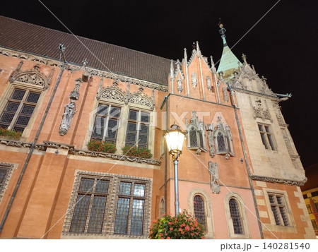 Old Town City Hall Building in Wroclaw Poland with Gothic Architecture Facade and Spires at Night. Street lamp light fixture 140281540