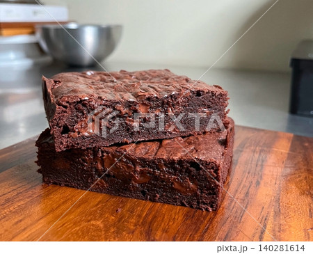 Rich, gooey fudge brownies with a dense, chocolatey center and a perfectly crisp top. Ideal for chocolate lovers craving a satisfying, indulgent treat. Rich, gooey fudge brownies with a dense, chocolatey center and a perfectly crisp top. Ideal for chocolate lovers craving a satisfying, indulgent treat. 140281614